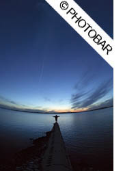 boy with arms outstretched at the end of dock in Rondeau Bay, Ontario